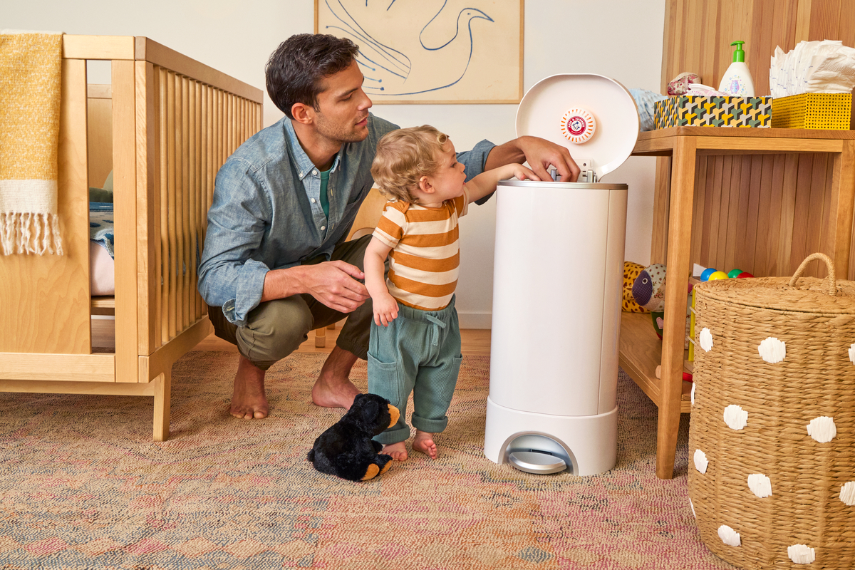 father with son throwing diaper away