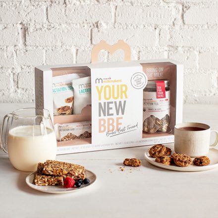 Munchkin "Your New BFF" new parent gift set displayed with milk, cookies, and snacks on a white surface against a white brick background.