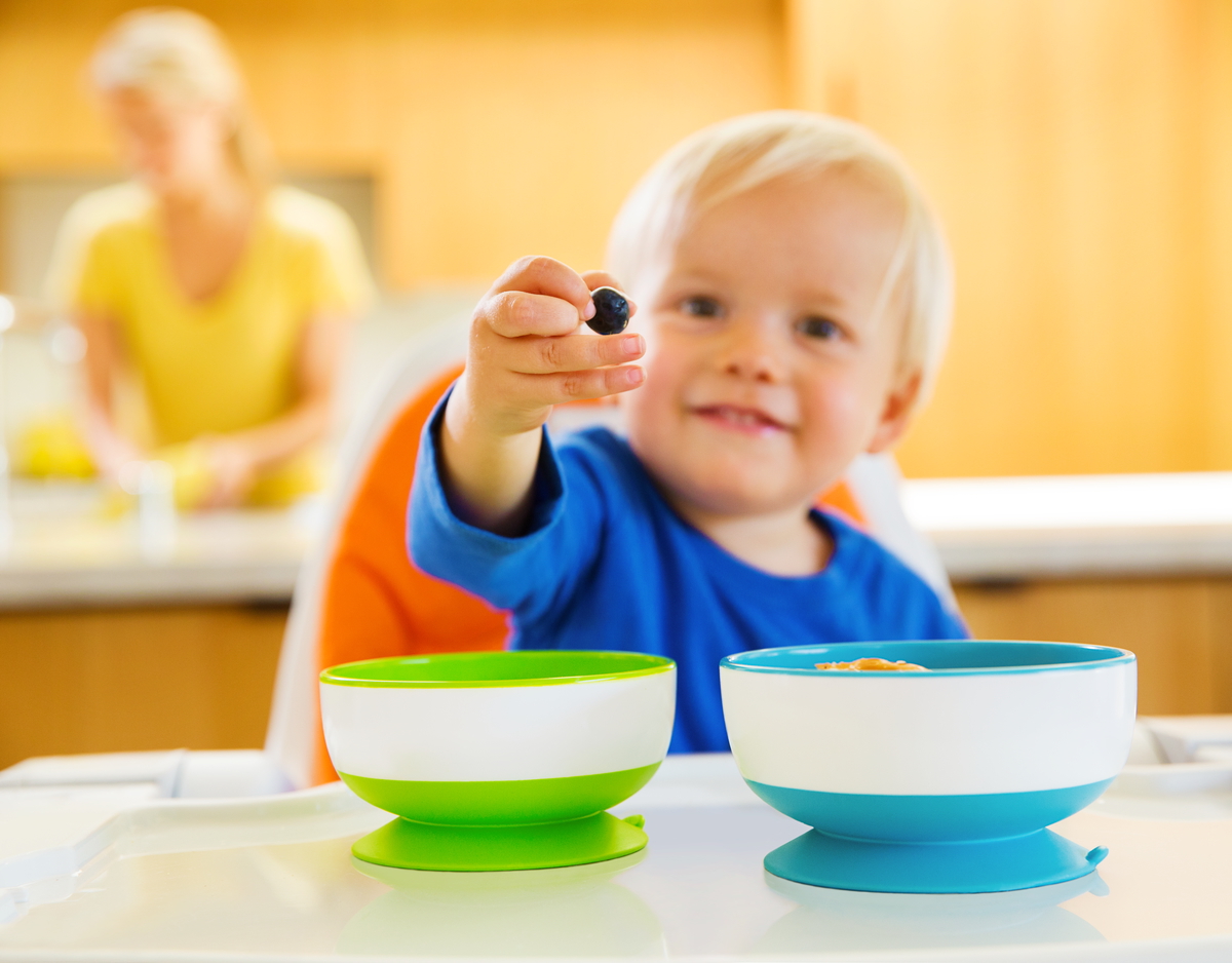 baby eating out off munchkin bowl