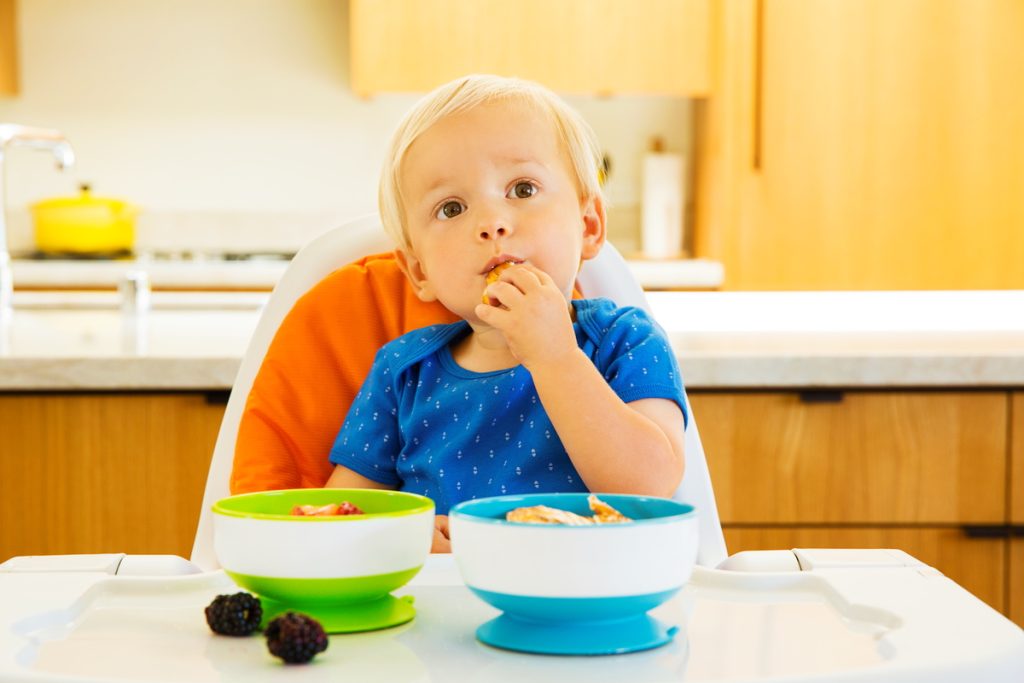 baby eating out off munchkin bowl