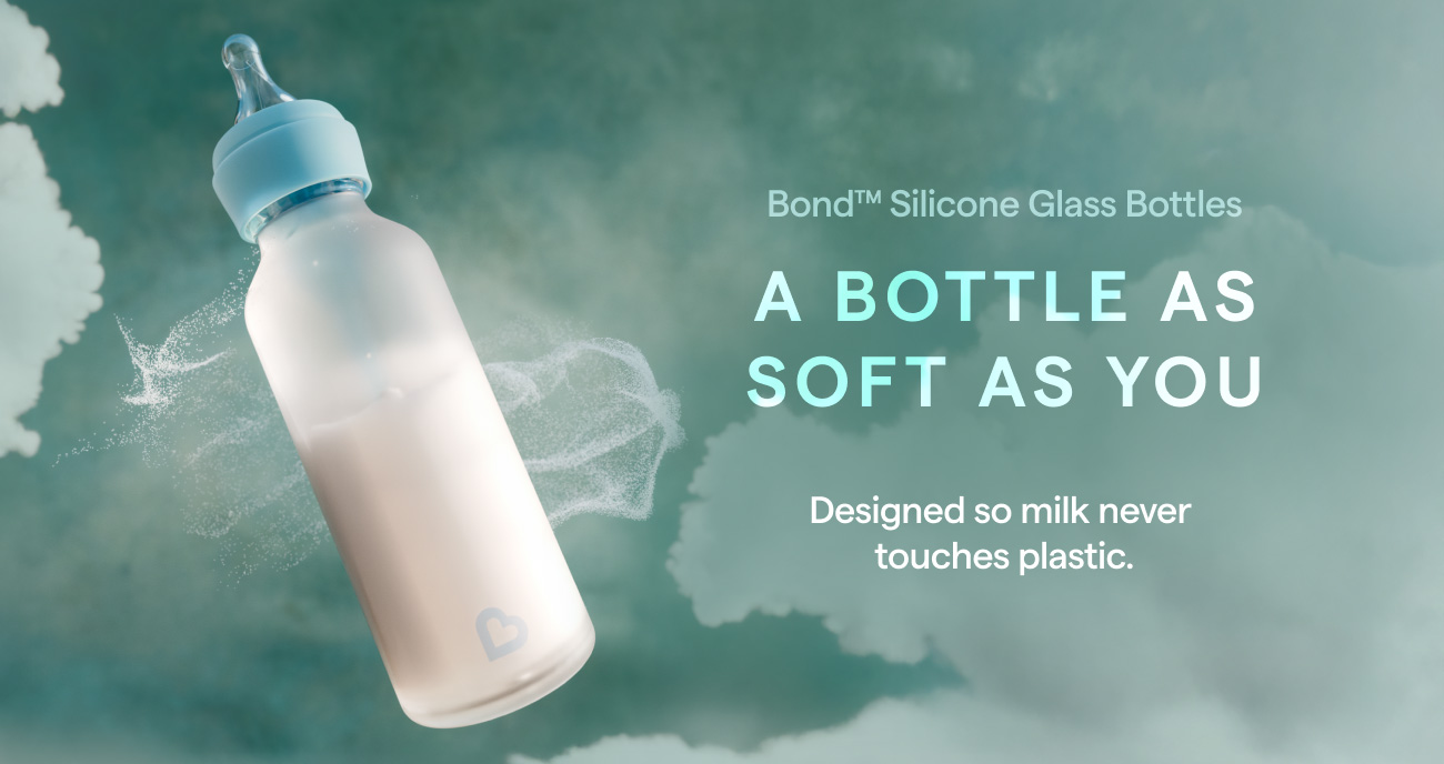 Bond Silicone Glass Bottle with blue nipple on a teal cloudy background, promotional text reads "A bottle as soft as you, designed so milk never touches plastic"
